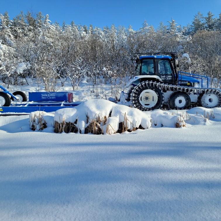 The club's Sno-Cleats tractor and Sur-Trac groomer in deep fresh snow