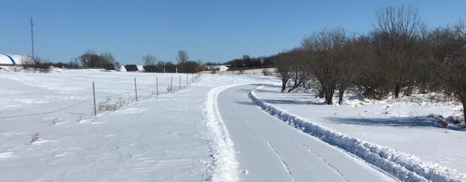 Groomed trail crossing open farmland